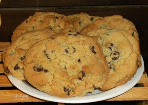 Soft and chewy on the inside and a little crunchy on the outside these favourites have kids of all ages coming back for more! Chocolate chips in every bite! A sheer delight! pic is of 6 delicious chocolate chip cookies on a white plate set on a wooden crate